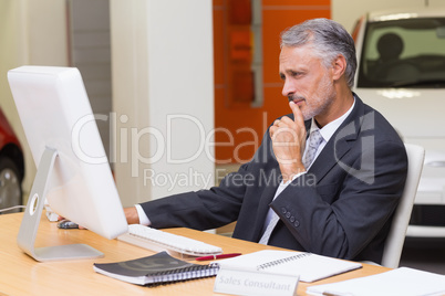 Focused businessman using his laptop