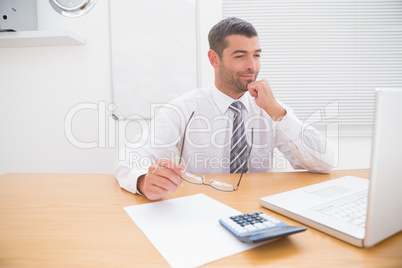 Businessman looking his laptop at his desk