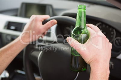 Man drinking beer while driving