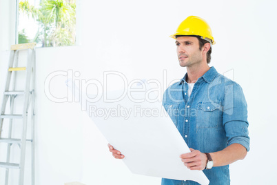 Architect holding blueprint in house