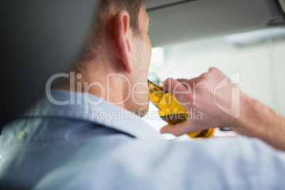 Man drinking beer while driving