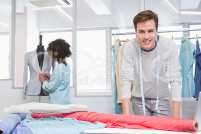 Smiling students working with fabric and model