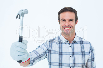 Happy handyman holding hammer