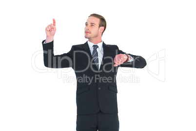 Cheerful businessman pointing up with finger