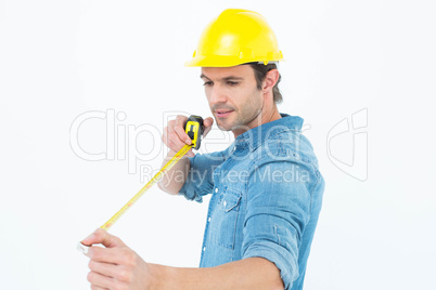 Male architect using tape measure