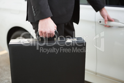 Close up of businessman holding a car door handles