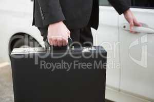 Close up of businessman holding a car door handles