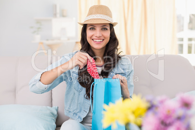 Pretty brunette opening shopping bag