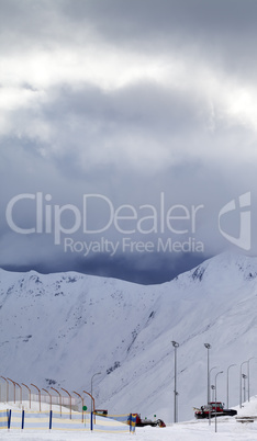 Ski slope and storm clouds in evening