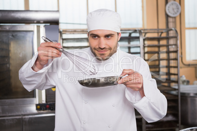 Smiling baker preparing a pastry