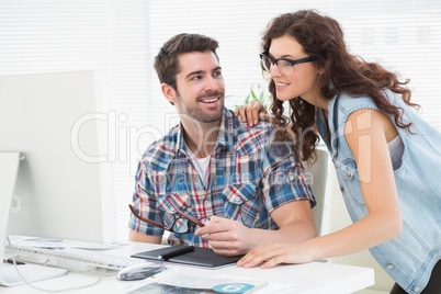 Cheerful partners using computer together