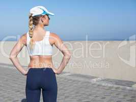 Fit blonde standing on the pier