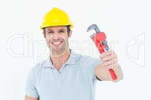 Happy handyman holding monkey wrench