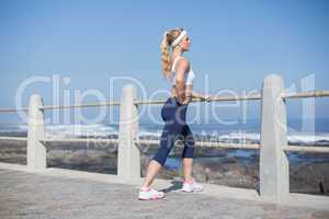 Fit woman stretching on the pier