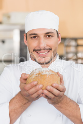 Baker smelling a freshly baked loaf