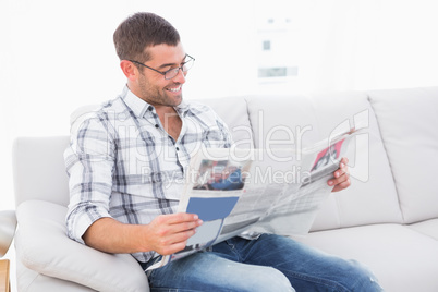 Relaxing man on a sofa with a newspaper