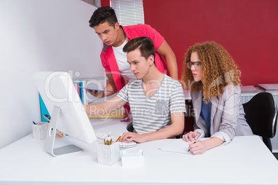 Concentrated students using tablet and computer