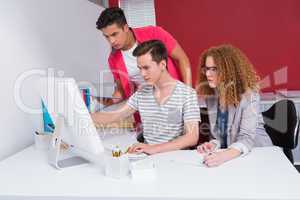 Concentrated students using tablet and computer