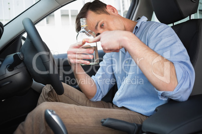 Man showing an empty bottle of vodka