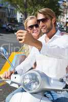 Cute couple riding a scooter