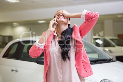 Smiling woman calling someone with her mobile phone