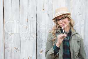 Portrait of blonde in hat posing and holding