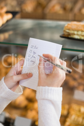 Woman checking her shopping list