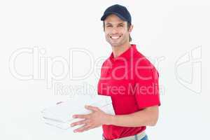 Happy delivery man holding pizza boxes