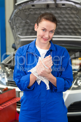 Mechanic wiping hands with rag