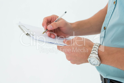Delivery man writing on clipboard