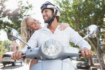 Cute couple riding a scooter