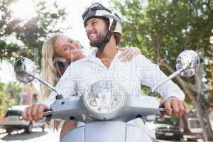 Cute couple riding a scooter