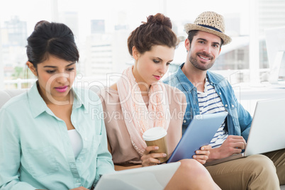 Business people working with laptop and tablet on couch