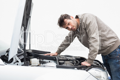 Stressed man looking at engine