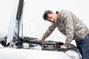 Stressed man looking at engine