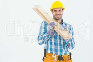 Construction worker carrying wooden planks