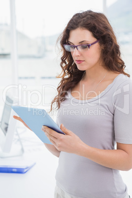 Portrait of concentrated businesswoman using tablet