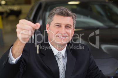 Smiling businessman holding a customer car key