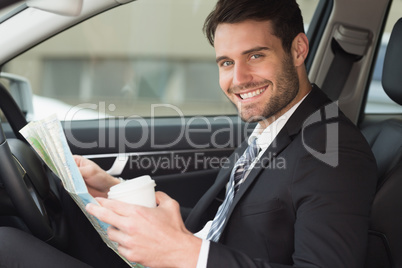 Young businessman reading a map