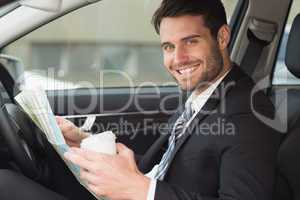 Young businessman reading a map