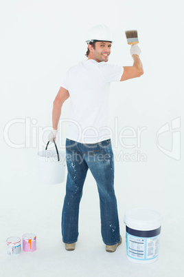 Happy man using paintbrush