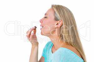 Pretty blonde eating a chocolate