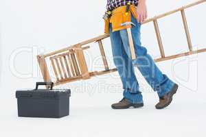 Low section of repairman carrying ladder