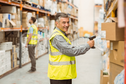 Warehouse worker scanning barcode on box