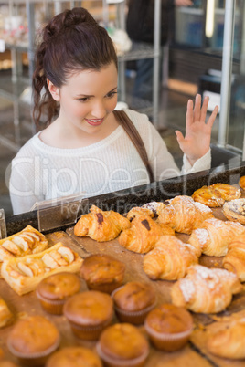 Pretty brunette looking at pastrys