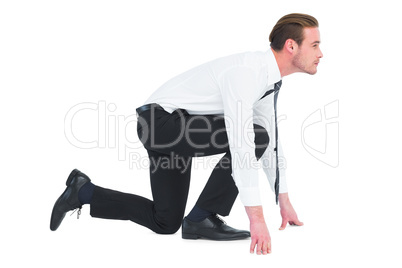 Businessman with hands and one knee on the floor