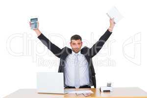 Businessman holding calculator and diary