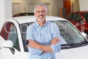 Smiling customer standing with arms crossed