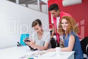 Smiling students working with camera together