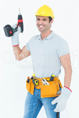 Carpenter holding cordless drill over white background